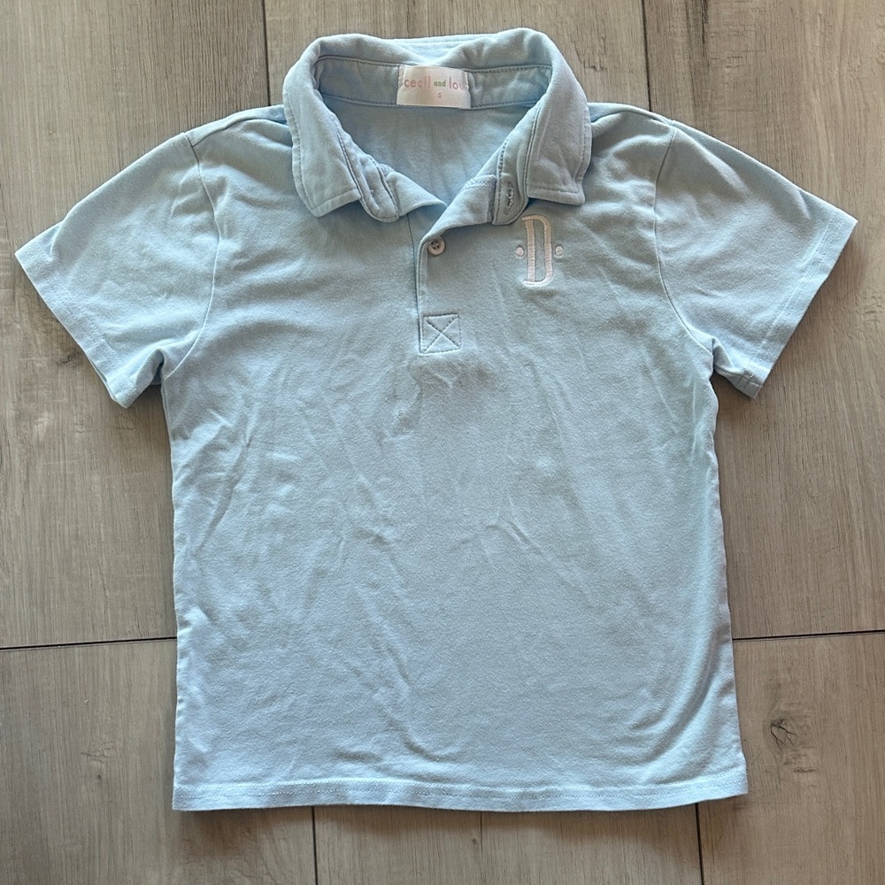 Kids Light Blue Polo Shirt; monogram “D”